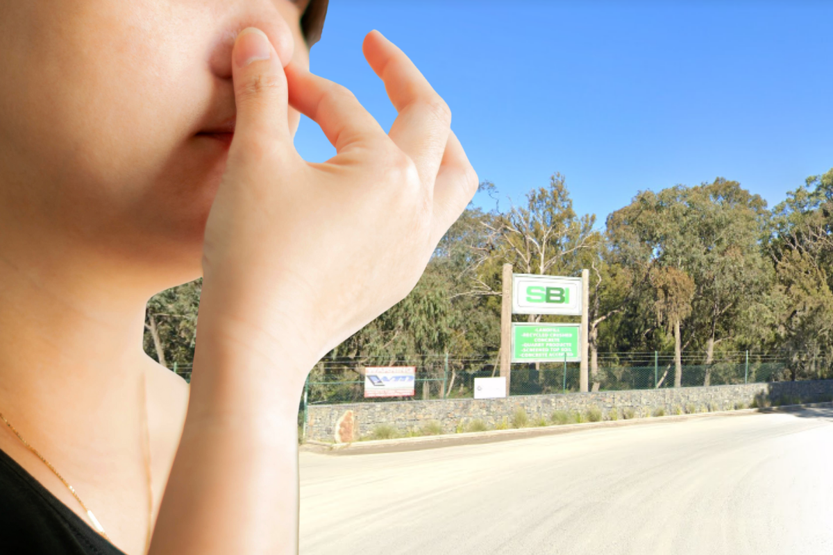 A woman holds her nose with her fingers in front of a tip sign