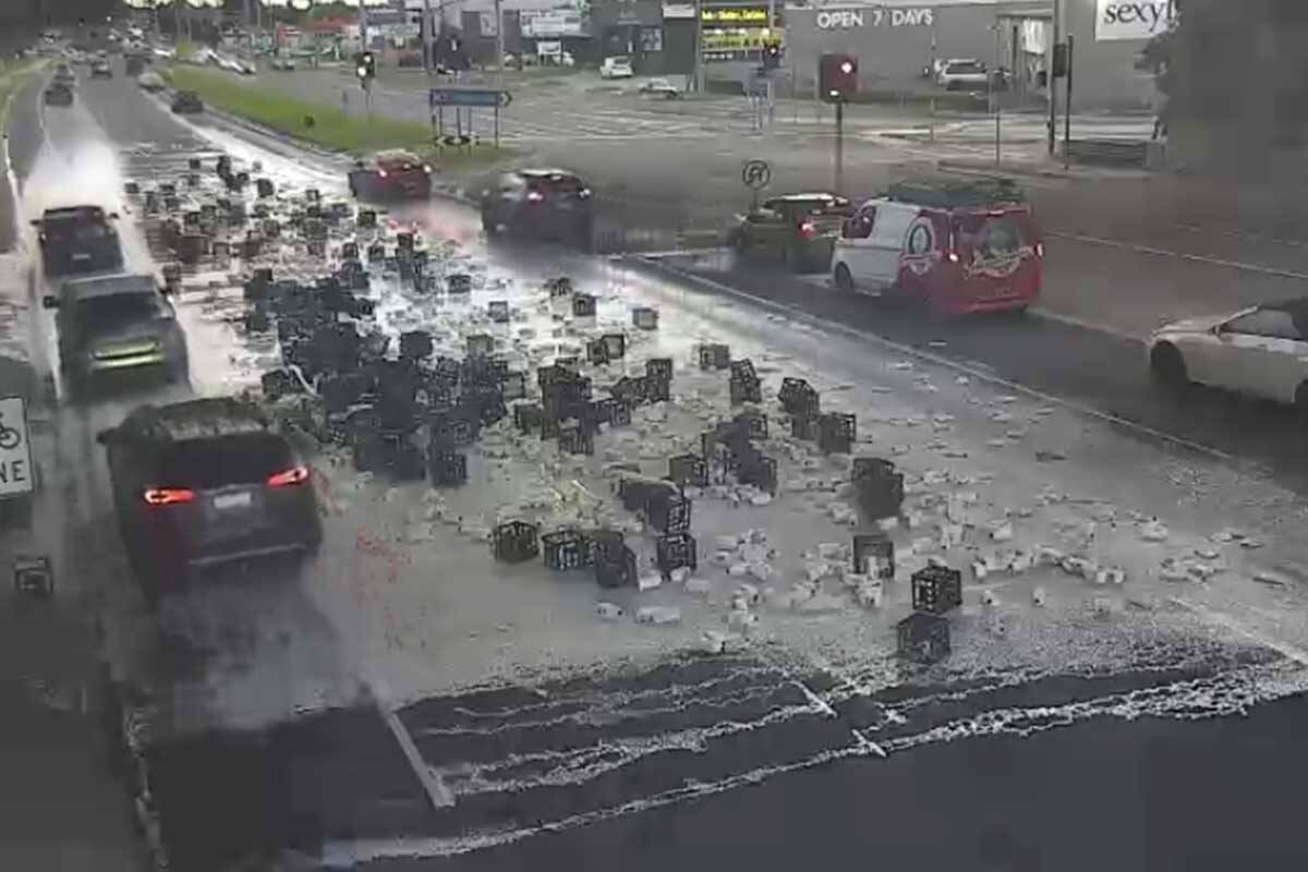 Article image for Busy road blocked after dozens and dozens of milk crates fall off truck